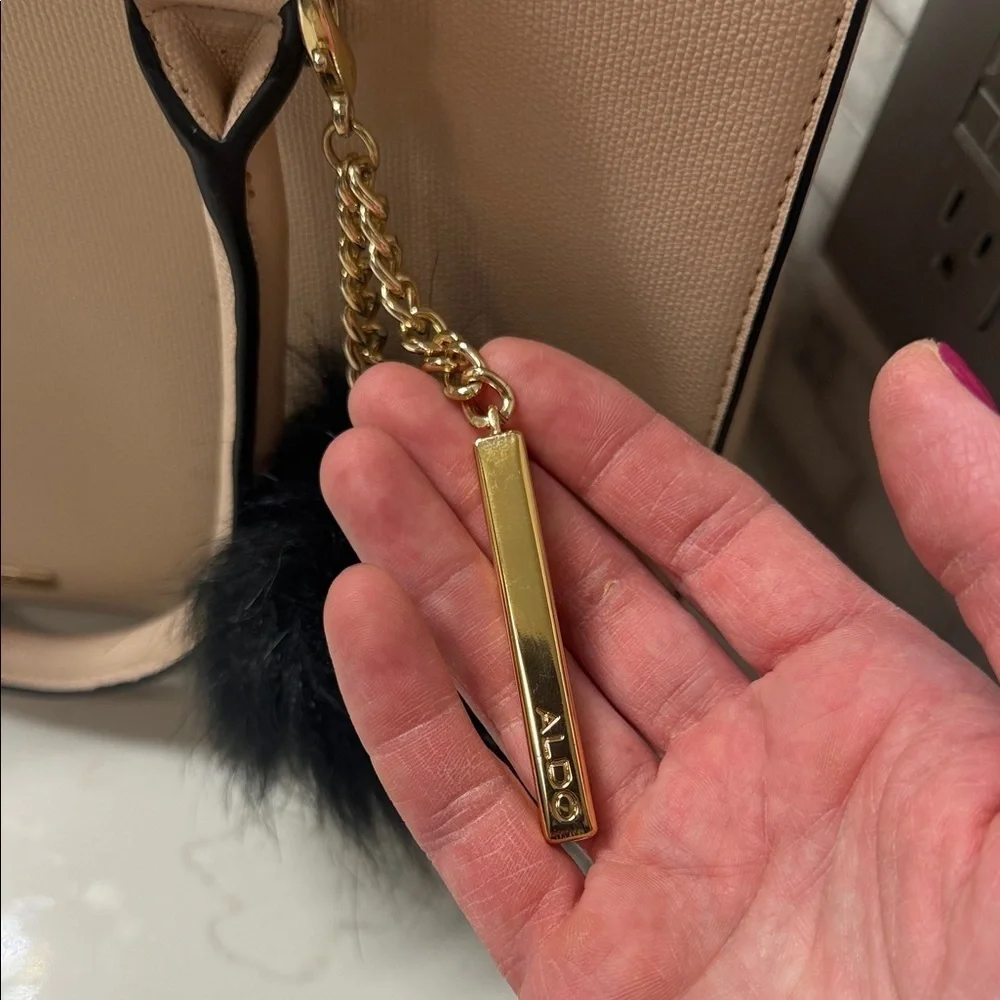 Elegant Cream Handbag with Black Charm